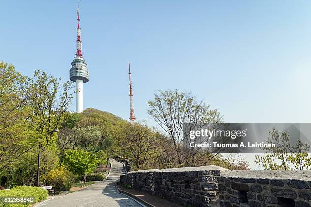 walkway, old fortress wall (or city wall) and n seoul tower at the namsan hill (or namsan park or namsan mountain) in seoul, south korea. - namsan seoul bildbanksfoton och bilder