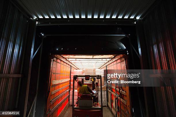 An employee uses a forklift truck to load goods into a distribution truck at the Ikea AB distribution center in Yesipovo village, near Moscow, on...