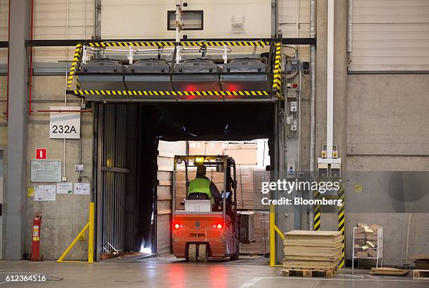 An employee uses a forklift truck to move goods into a distribution truck at the Ikea AB distribution center in Yesipovo village, near Moscow, on...