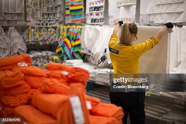 An employee inspects a white towel in the Ikea AB retail store in Khimki, Russia, on Monday, Oct. 3, 2016. Ikea's Russia unit may spend 100 billion...