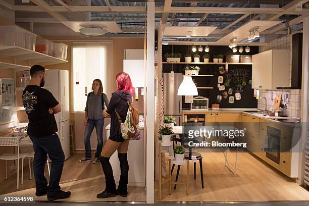 Customers browse a show kitchen inside the Ikea AB retail store in Khimki, Russia, on Monday, Oct. 3, 2016. Ikea's Russia unit may spend 100 billion...