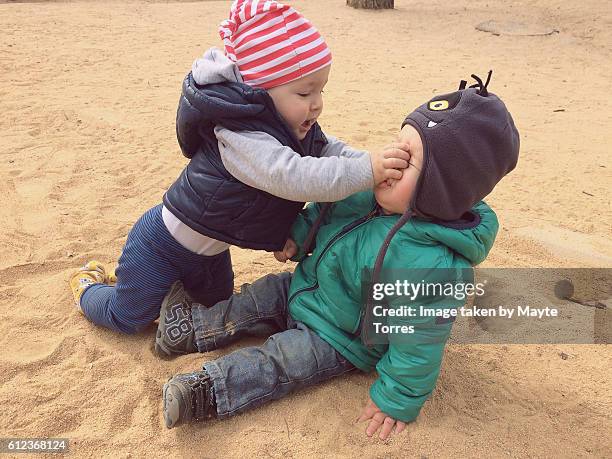 one year old boys at the playground being rude - conflict of interest stock pictures, royalty-free photos & images