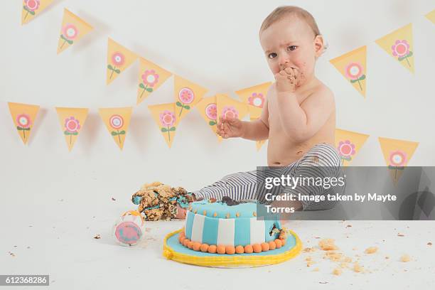 one year old destroying birthday cake - demolished cake stock pictures, royalty-free photos & images