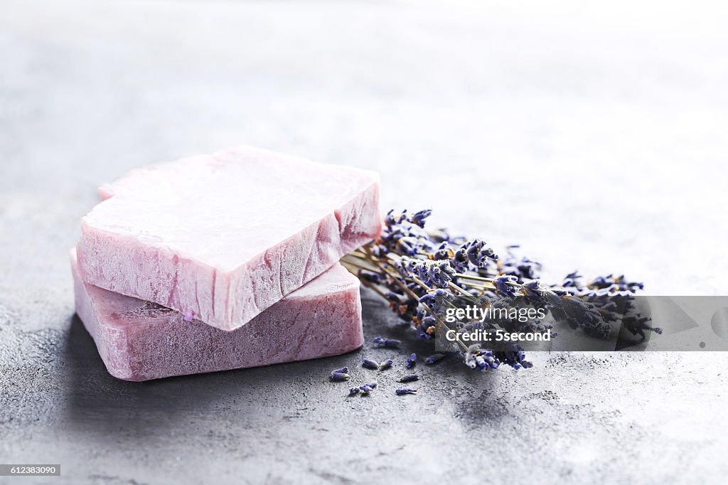 Lavender flowers and soap on grey table