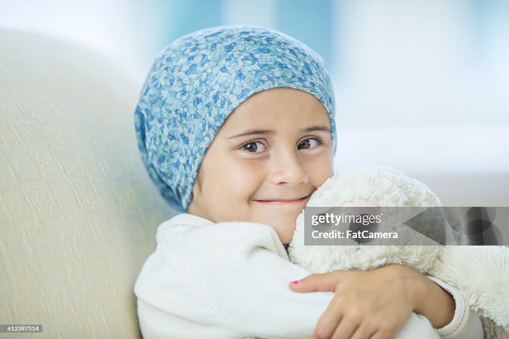 Child with Cancer Hugging Her Stuffed Animal