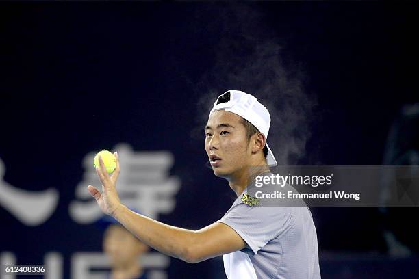 Zhang Ze of China serves against Jack Sock of USA during the Men's singles first round match on day four of the 2016 China Open at the China National...