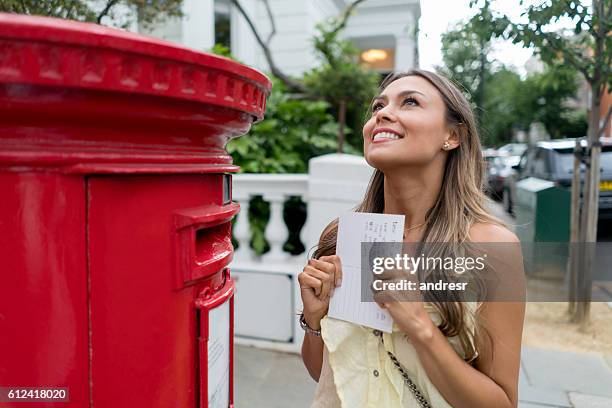 excited woman sending a postcard - postcard stock pictures, royalty-free photos & images