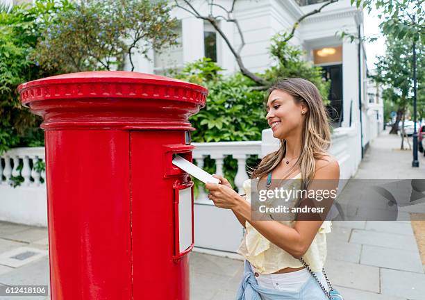 woman sending postcard through the mail - message sent stock pictures, royalty-free photos & images