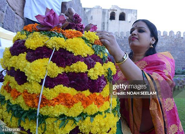 An Indian Hindu prepares a floral displays ahead of rituals as they celebrate the 'Bathukamma' or 'Life Giver' Festival in Hyderabad, on October 4,...