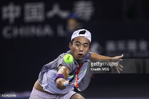 Zhang Ze of China returns a shot against Jack Sock of the United States during the Men's singles first round match on day four of the 2016 China Open...