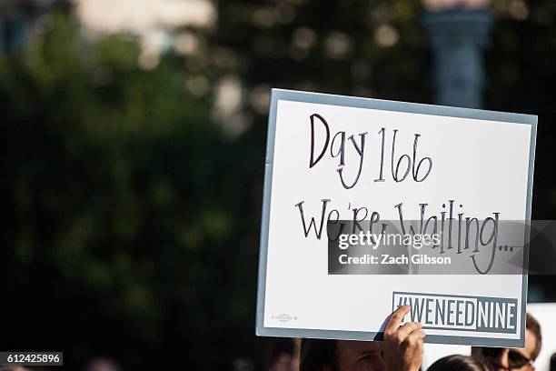 Demonstrator holds a sign during a rally urging the U.S. Senate to hold a confirmation vote for Supreme Court Nominee Merrick Garland outside of The...