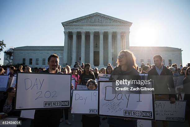 Demonstrators hold signs while gathering for a group photo during a demonstration urging the U.S. Senate to hold a confirmation vote for Supreme...
