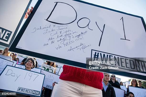 Demonstrators hold signs while gathering for a group photo during a demonstration urging the U.S. Senate to hold a confirmation vote for Supreme...