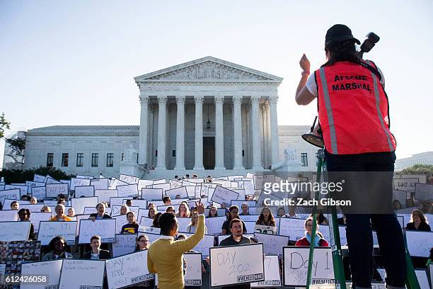 Lauren Santa Cruz organizes demonstrators for a group photo during a demonstration urging the U.S. Senate to hold a confirmation vote for Supreme...