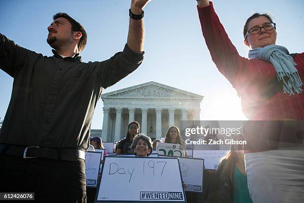 Demonstrators hold signs while gathering for a group photo during a demonstration urging the U.S. Senate to hold a confirmation vote for Supreme...