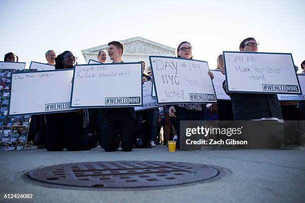 Demonstrators hold signs while gathering for a group photo during a demonstration urging the U.S. Senate to hold a confirmation vote for Supreme...