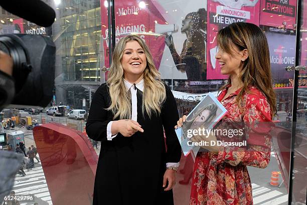 Hilaria Baldwin interviews Kelly Clarkson during her visit to "Extra" at their New York studios at H&M in Times Square on October 4, 2016 in New York...