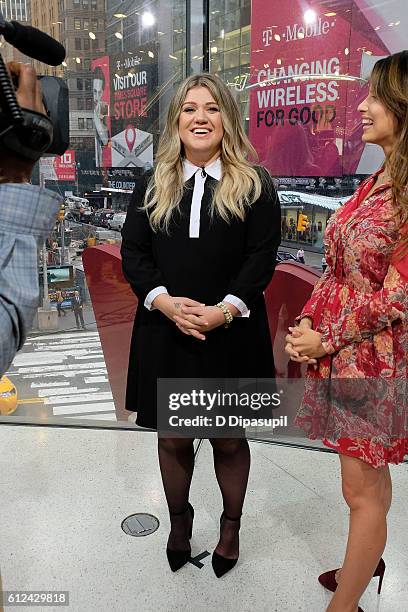 Hilaria Baldwin interviews Kelly Clarkson during her visit to "Extra" at their New York studios at H&M in Times Square on October 4, 2016 in New York...