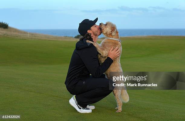 Tommy Fleetwood of England is greeted by his prized pooch "Cooky" as he plays in a practice round during the Alfred Dunhill Links Championship...