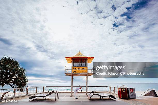 man performing morning exercise at surfer's paradise main beach - main beach gold coast stock pictures, royalty-free photos & images
