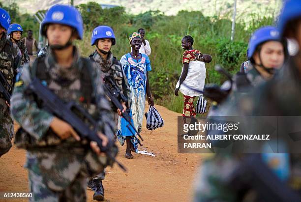 Peacekeeper troops from China deployed by the United Nations Mission in South Sudan , patrol on foot outside the premises of the UN Protection of...