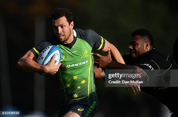 Luke Morahan of Australia evades a tackled during an Australia training session at the Lensbury Hotel on October 4, 2016 in London, United Kingdom.