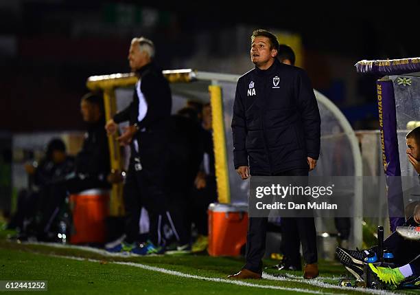 Neal Ardley, Manager of AFC Wimbledon looks on during the EFL Checkatrade Trophy match between AFC Wimbledon and Plymouth Argyle at The Cherry Red...