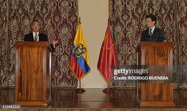 China's Foreign Minister Wang Yi and his Ecuadorean counterpart Guillaume Long speak to the press after holding a meeting in Quito, on October 4,...