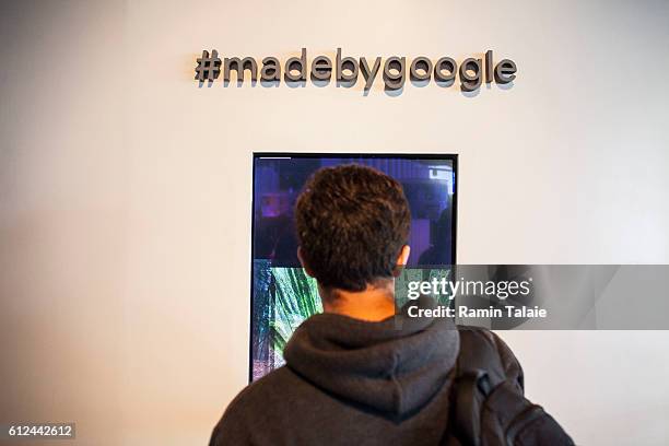 Members of the media examine Google's Pixel phone during an event to introduce Google hardware products on October 4, 2016 in San Francisco,...