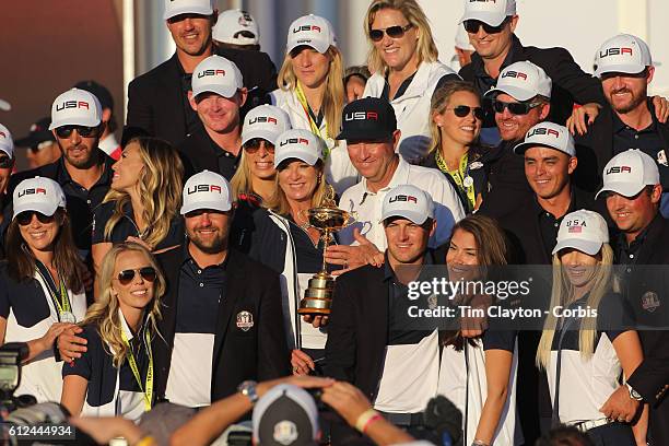 Ryder Cup 2016. Day Three. The United States team players and their spouses and partners celebrate with the Ryder Cup after the United States victory...