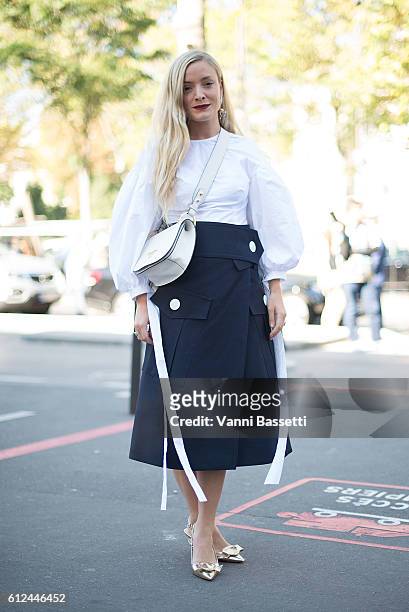 Kate Foley poses with a Prada bag after the Ellery show at the Palais de Tokyo during Paris Fashion Week SS17 on October 4, 2016 in Paris, France.