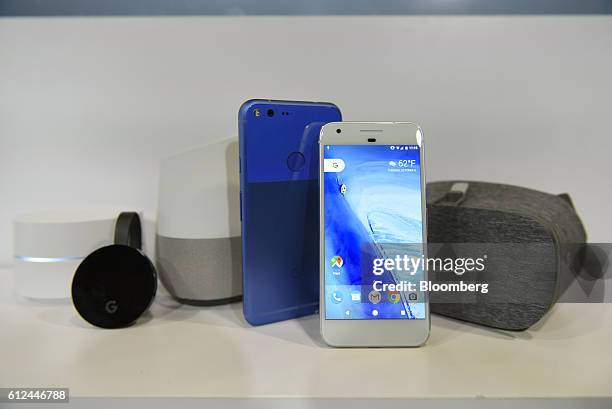 The Google Wifi router, from left, Chromecast Ultra, Home, Pixel XL, Pixel, and Daydream View devices sit on display during a product launch event in...