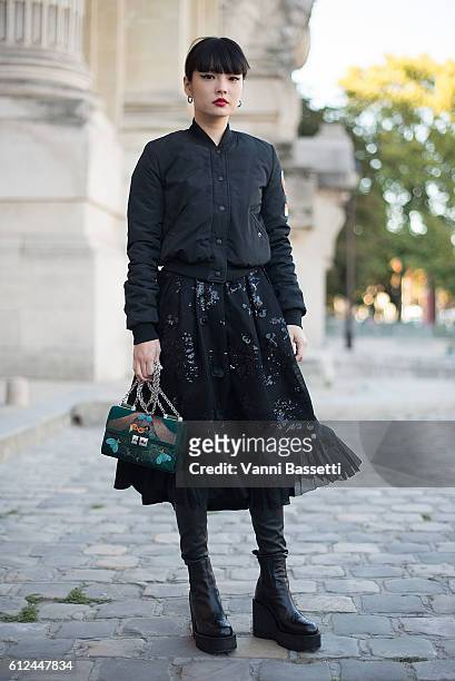 Kozue Akimoto poses wearing Shiatzy Chen before the Shiatzy Chen show at the Grand Palais during Paris Fashion Week SS17 on October 4, 2016 in Paris,...