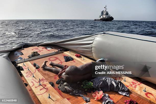 Graphic content / A dead body lies on a boat after some migrants were rescued by members of Proactiva Open Arms NGO in the Mediterranean Sea, some 12...