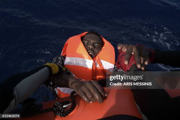 Migrant is rescued by members of Proactiva Open Arms NGO in the Mediterranean Sea, some 12 nautical miles north of Libya, on October 4, 2016. At...