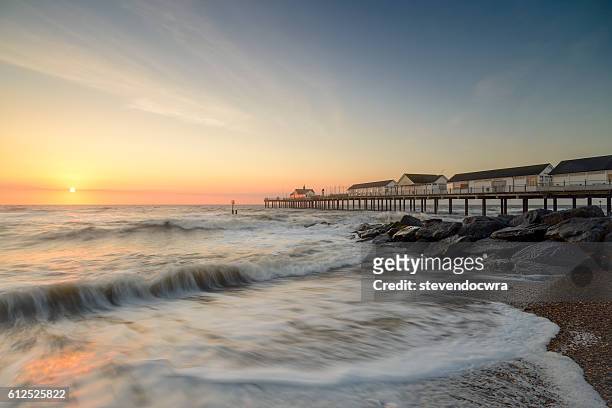 southwold pier on the suffolk coast, bathed in early morning sunlight - high tide stock pictures, royalty-free photos & images