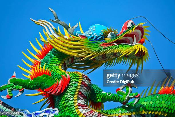 chinese dragon against clear sky - chinesischer drache stock-fotos und bilder