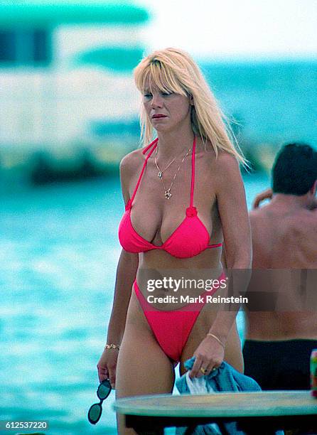 Dressed in a bikini, an unidentified 'Baywatch Hawaii' extra walks on the television series' set, Honolulu, Hawaii, July 20, 1999.