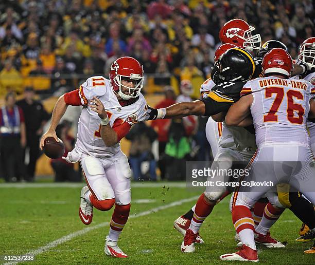 Quarterback Alex Smith of the Kansas City Chiefs tries to avoid the reach of defensive lineman Cameron Heyward of the Pittsburgh Steelers as...