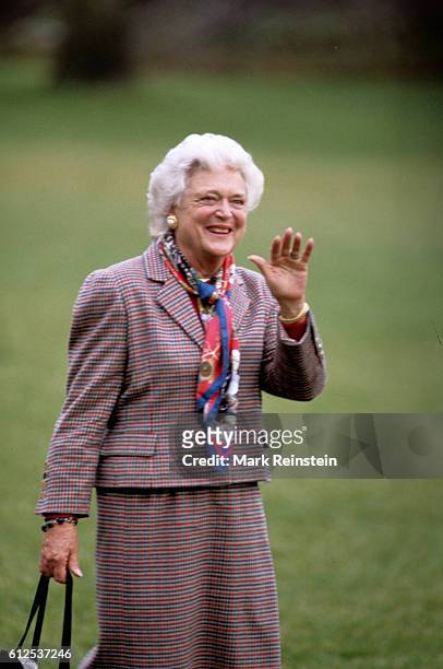 First Lady Barbara Bush waves as she walks on the South Lawn of the White House, Washington DC, April 6, 1990. She was preparing to board Marine One...
