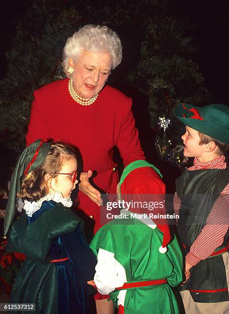 First Lady Barbara Bush plays with several of her grandchildren, in costume as elves, during a White House Christmas celebration, Washington DC,...