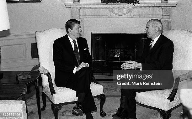 American President Ronald Reagan and Austrian President Rudolf Kirchschlager talk together in the White House's Oval Office during the latter's State...