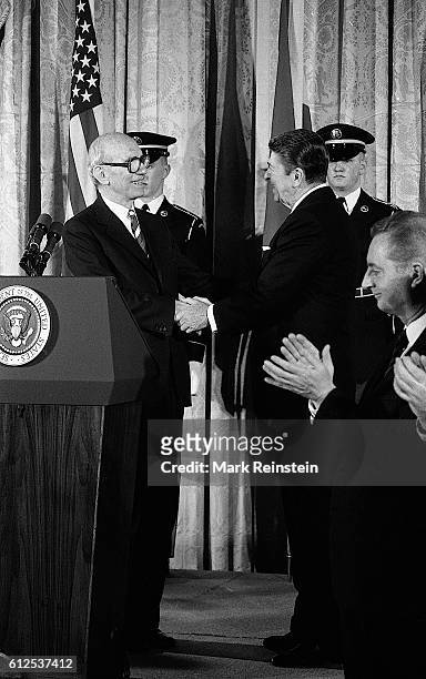 During a State Visit, Austrian President Rudolf Kirchschlager shakes hands with American President Ronald Reagan in the White House's East Room...
