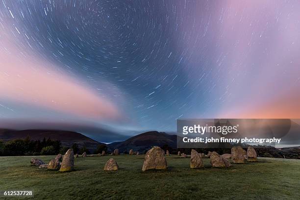 castlerigg stone circle star trails. lake district national park. uk. europe. - stone circle stock pictures, royalty-free photos & images