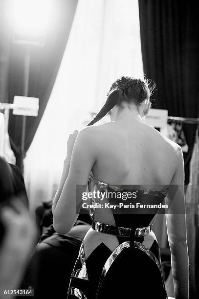 Model waits backstage prior to the Valentin Yudashkin show as part of the Paris Fashion Week Womenswear Spring/Summer 2017 on October 4, 2016 in...