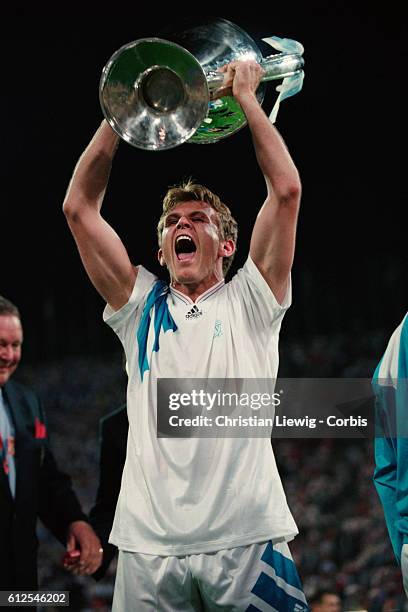 S Franck Sauzee holds the trophy after his team won the 1993 UEFA Champions League Final against AC Milan 1-0.