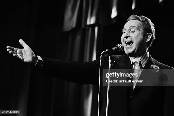 French singer and songwriter Charles Trenet on stage at the Bobino music hall, in Paris.