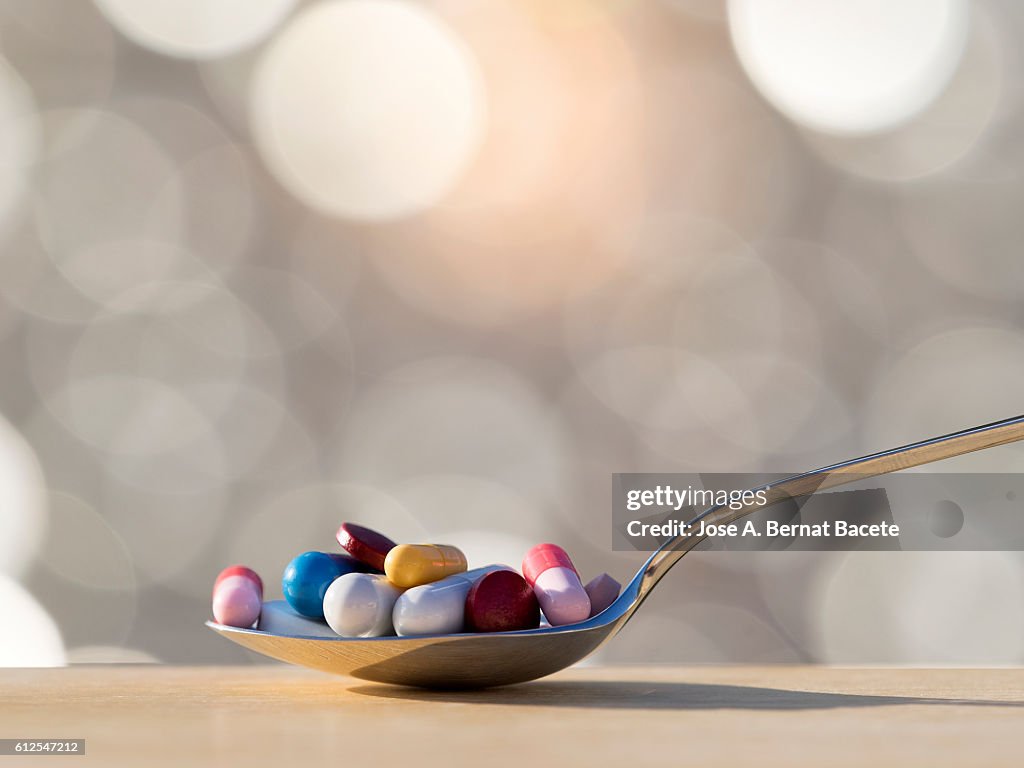 Teaspoon of medicines in tablets and pills.  Medicine abuse