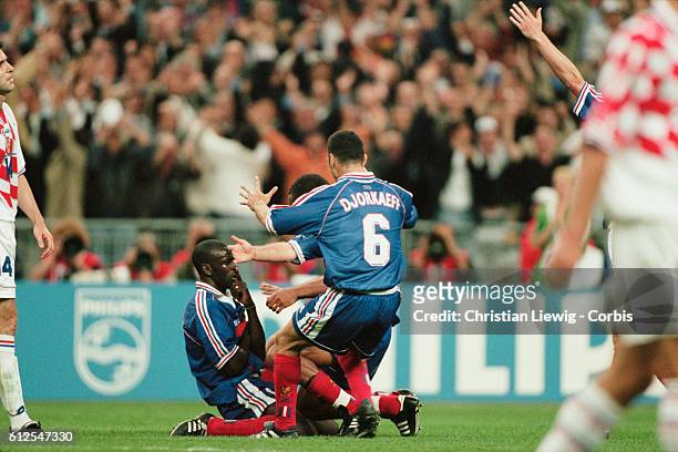 France's Lilian Thuram celebrates scoring his second goal in the semi-finals match of the 1998 FIFA World Cup against Croatia. | Location:...