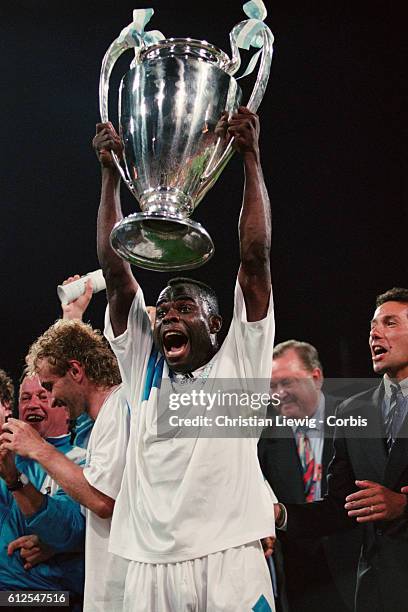 S Basile Boli holds the trophy after his team won the 1993 UEFA Champions League Final against AC Milan 1-0.